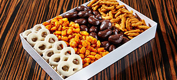 Sweet and salty snack box with chocolate covered pretzels and nuts